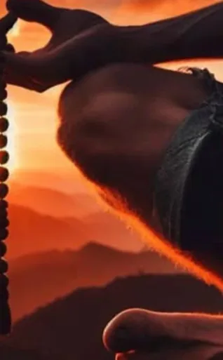 A hand with prayer beads held against an orange mountain sunrise, from Alchemy’s Sunrise Yoga poster.
