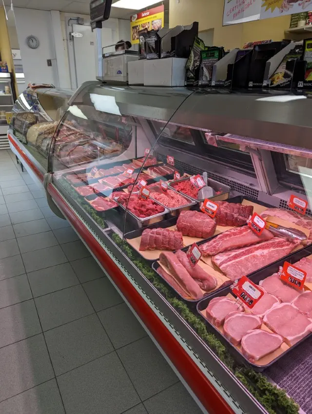 A long glass meat case filled with fresh cuts inside Ivan’s Meat and Deli