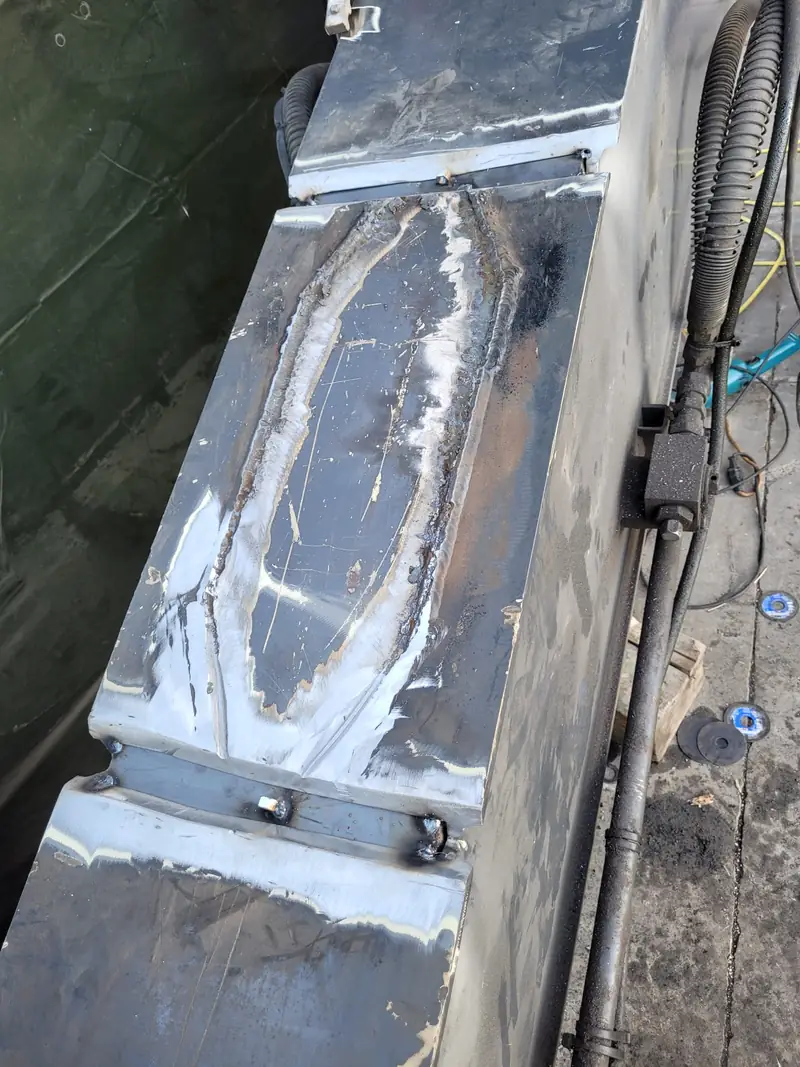 The excavator boom with the repair welded in