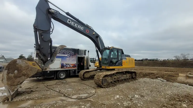 PineGrove service truck parked beside an excavator on a gravel job site