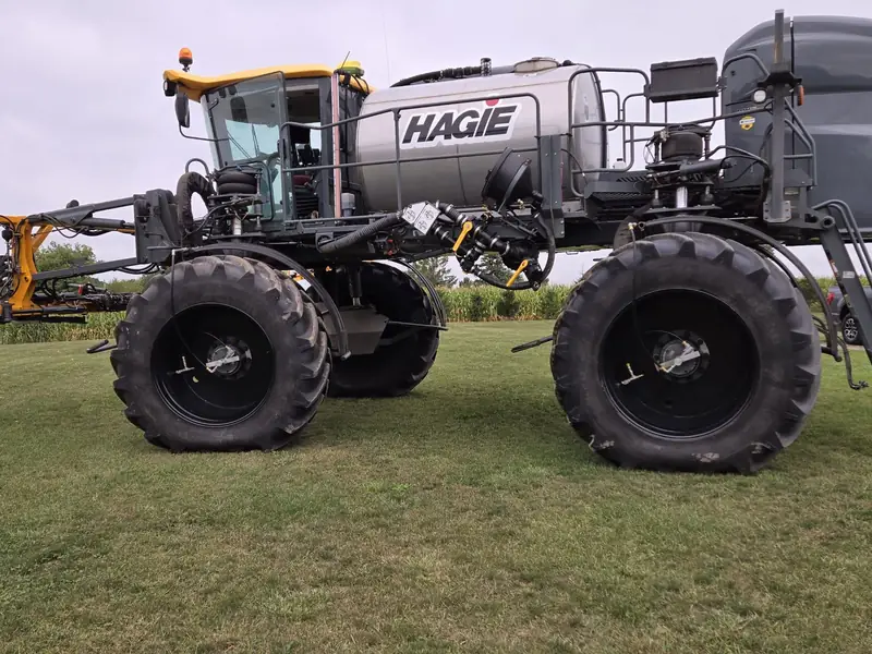 Sprayer on large tires parked on grass, from the AgriBrink dealer announcement