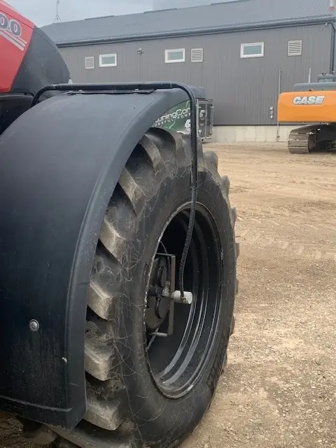 Tire under a fender with an air line running to the wheel hub